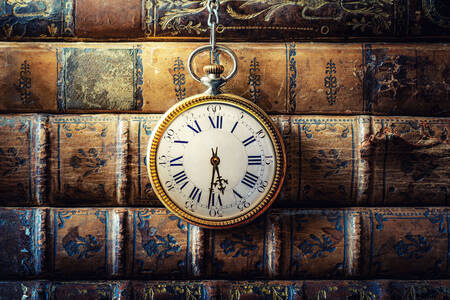 Vintage clocks on old books